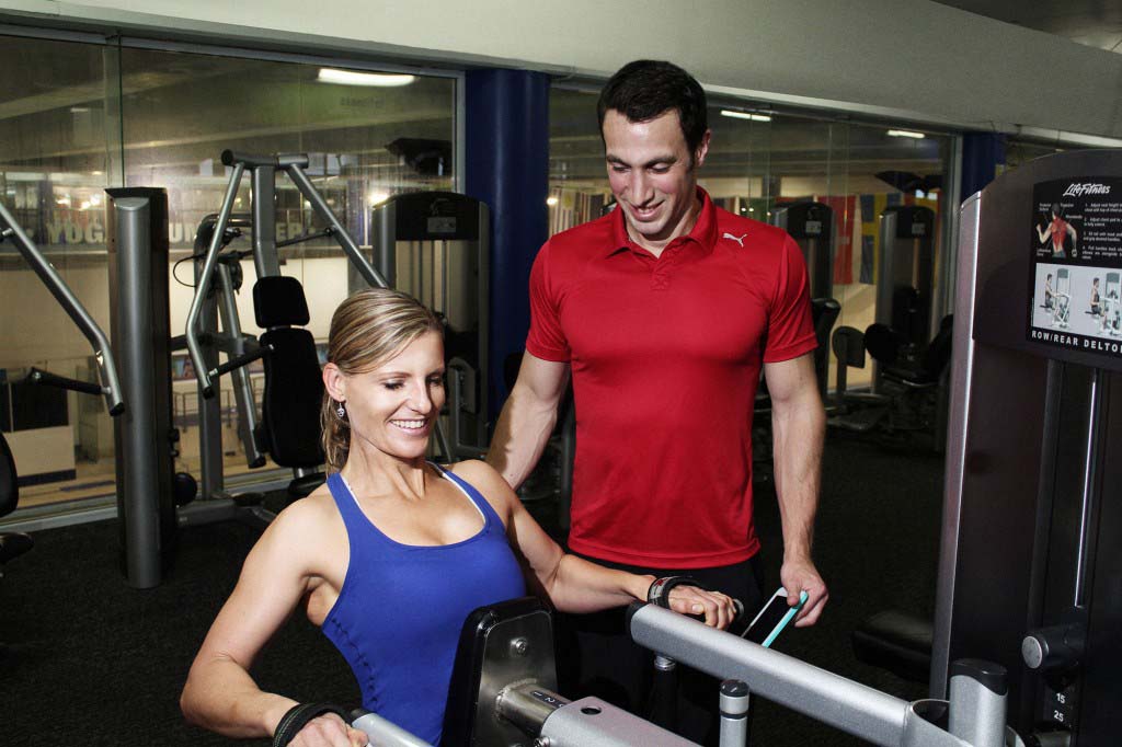 A woman does resistance exercises with her trainer